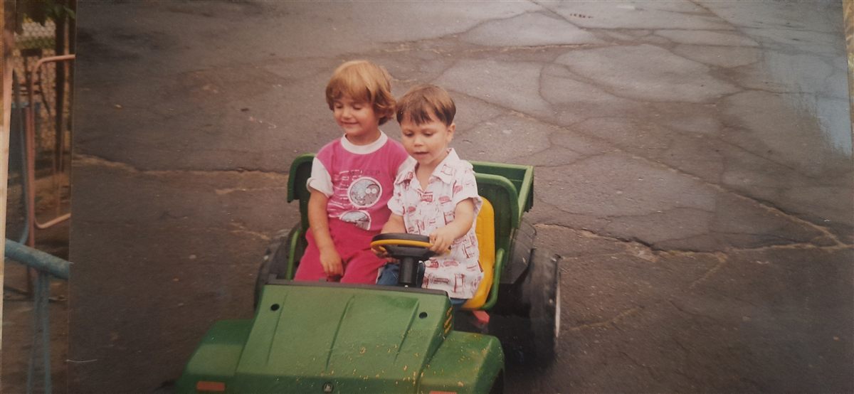 Mark as a child driving a toy car